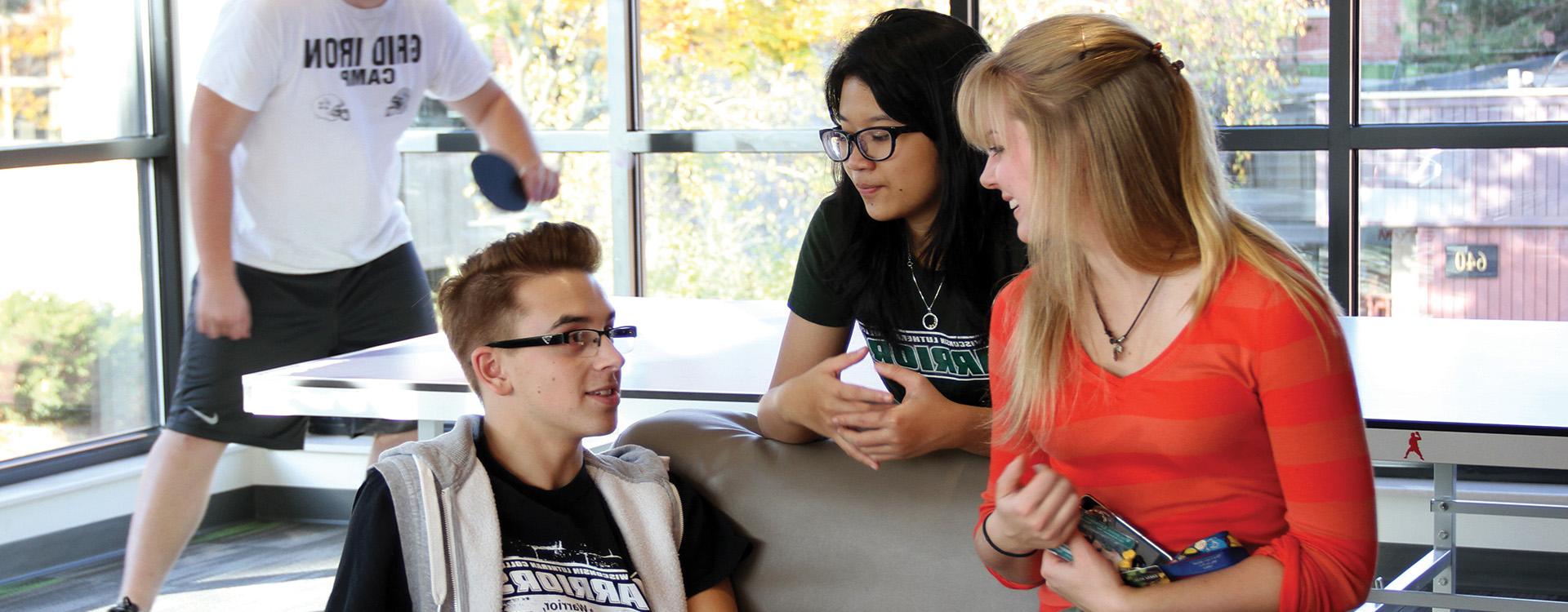 Students hanging out in Aspire Hall common area